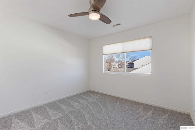 carpeted spare room with ceiling fan