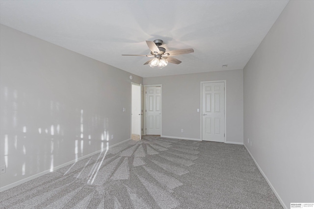 spare room featuring carpet flooring and ceiling fan