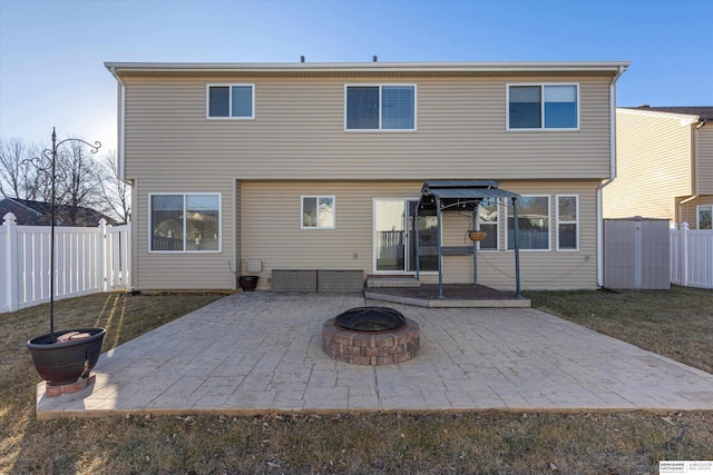 back of property featuring a patio, a yard, and an outdoor fire pit