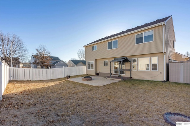 back of property featuring a patio, a lawn, and an outdoor fire pit