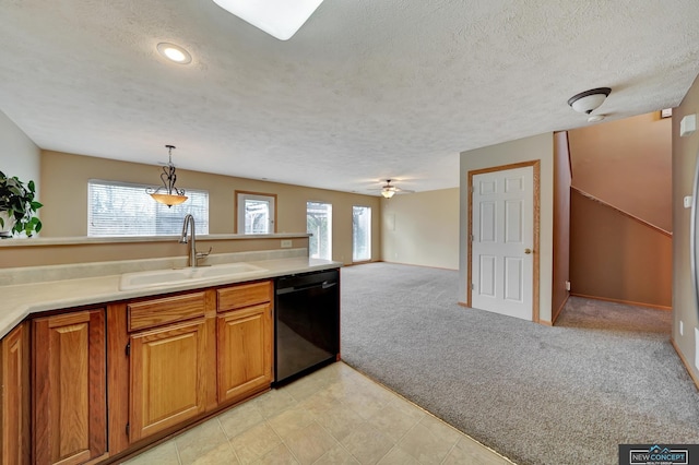 kitchen featuring sink, light carpet, black dishwasher, a wealth of natural light, and pendant lighting