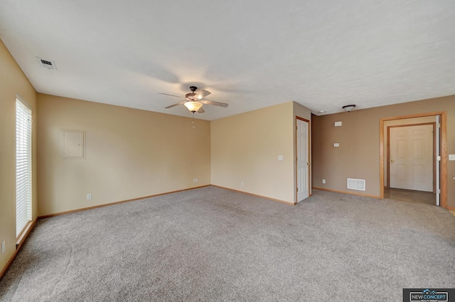 carpeted spare room featuring ceiling fan