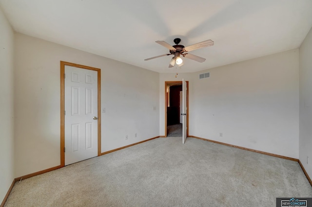 unfurnished room featuring light colored carpet and ceiling fan