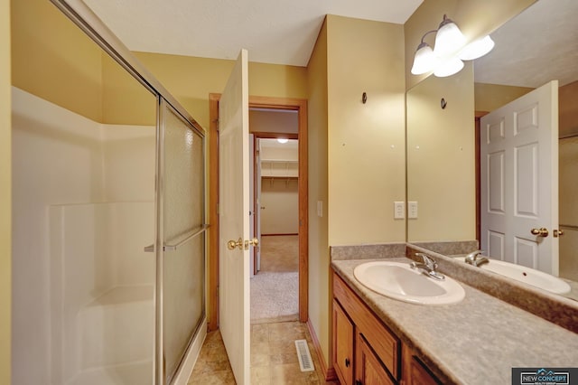 bathroom with vanity and walk in shower