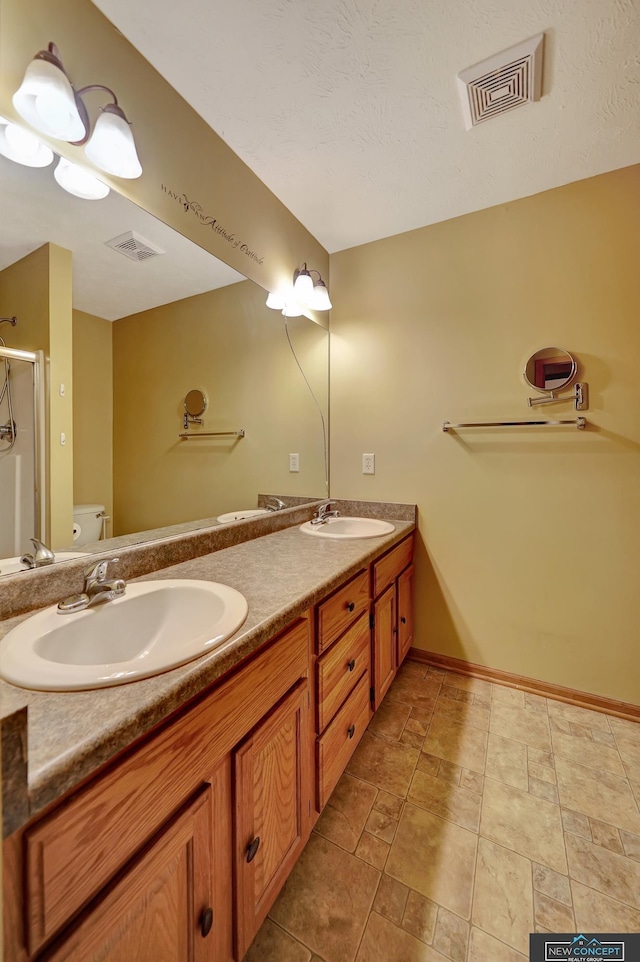 bathroom featuring vanity, toilet, and an enclosed shower