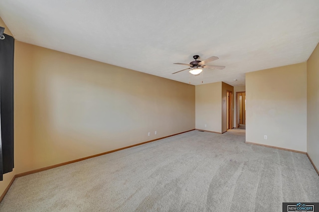 carpeted empty room featuring ceiling fan