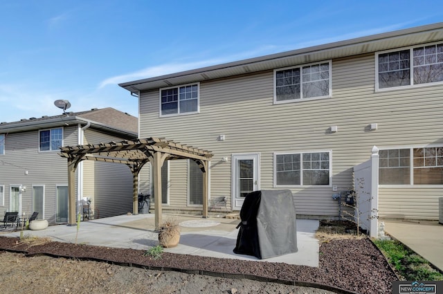 rear view of house with a pergola and a patio