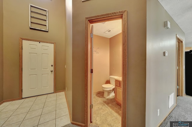 bathroom with vanity, tile patterned flooring, a textured ceiling, and toilet