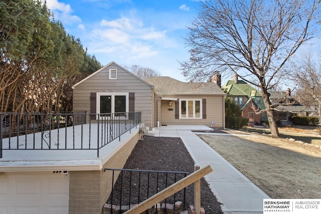 rear view of house featuring a garage