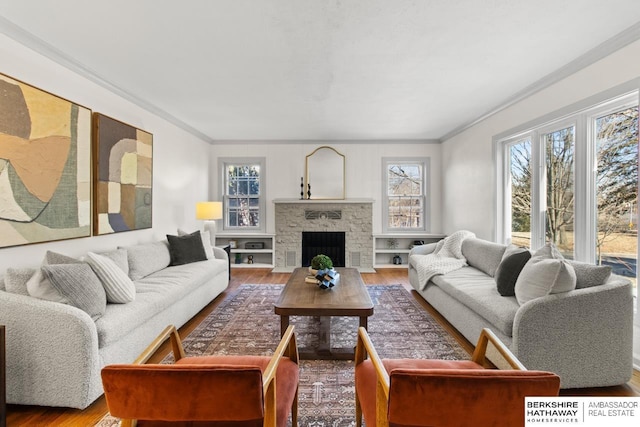 living room featuring crown molding, wood-type flooring, and a fireplace