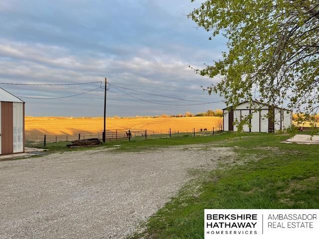 surrounding community featuring an outdoor structure and a rural view