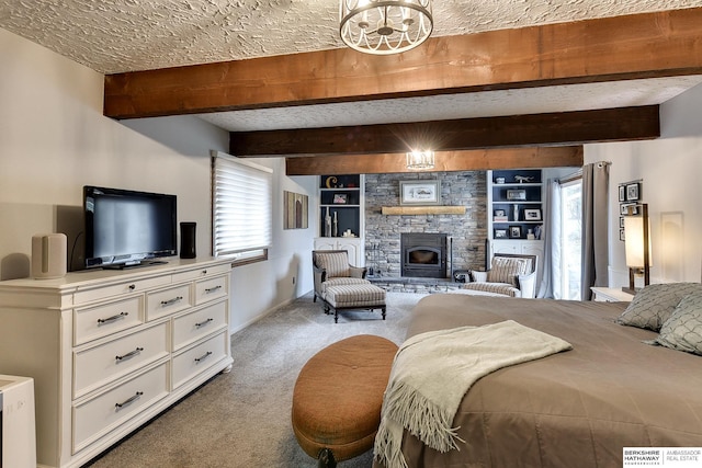 bedroom with a stone fireplace, carpet floors, a textured ceiling, and beamed ceiling