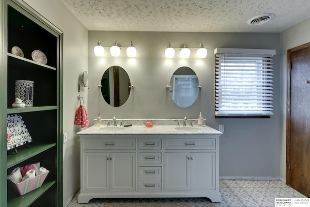 bathroom with vanity and a textured ceiling