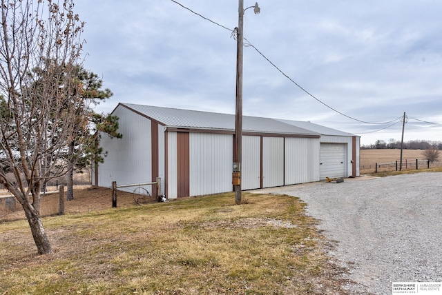 view of outbuilding featuring a garage and a yard