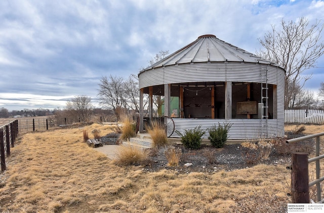 view of front of home with a rural view