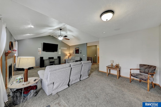 carpeted living room featuring vaulted ceiling, ceiling fan, and a textured ceiling