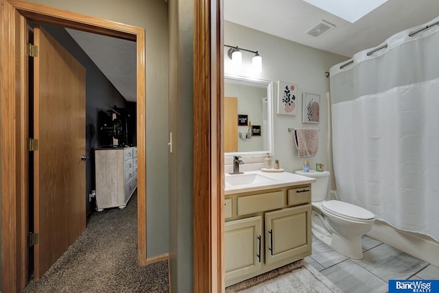 bathroom with vanity, a shower with shower curtain, and toilet