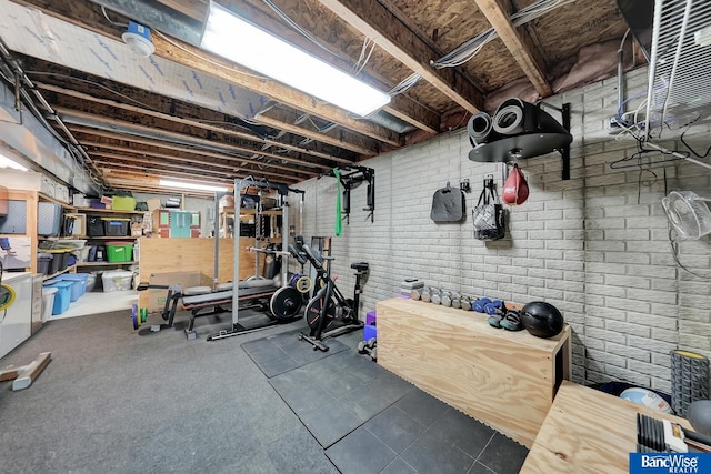 exercise area featuring brick wall