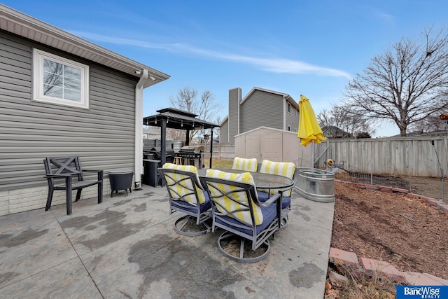 view of patio / terrace featuring a shed and a grill