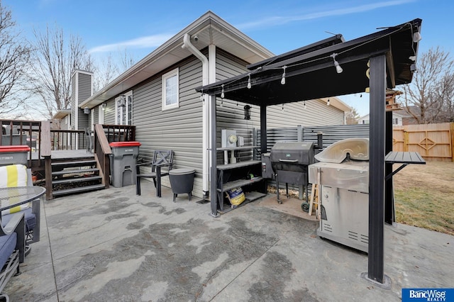 view of patio featuring a wooden deck and grilling area