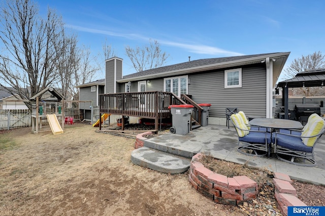 rear view of property with a playground, a patio, a gazebo, and a deck