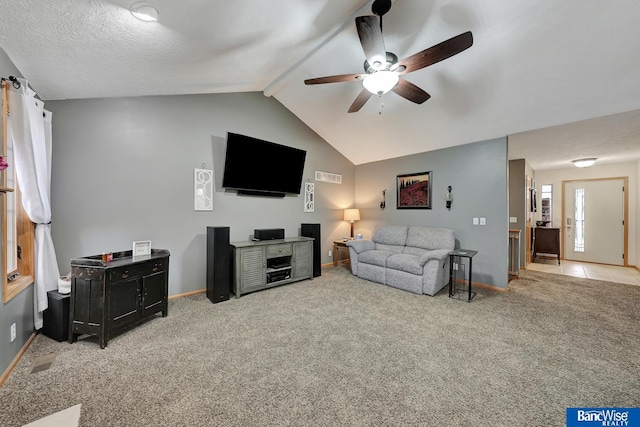 living room with ceiling fan, lofted ceiling with beams, and light carpet