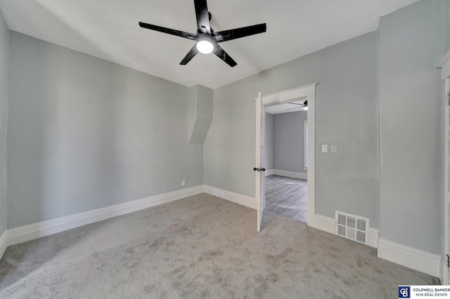 unfurnished room featuring light colored carpet and ceiling fan