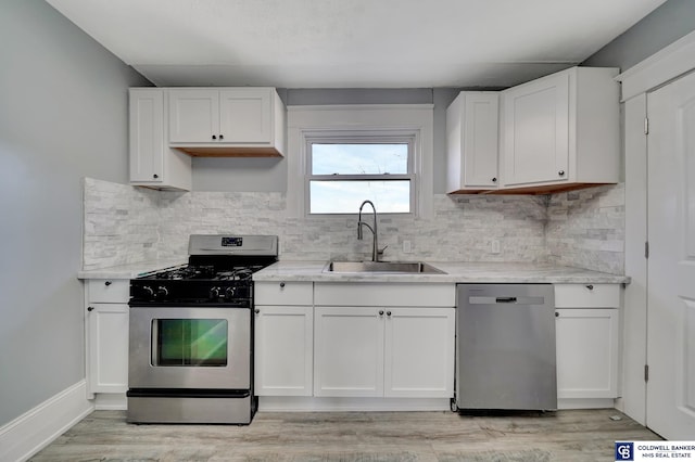 kitchen with white cabinetry, appliances with stainless steel finishes, and sink