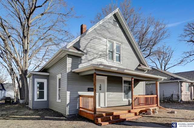 rear view of property with a porch