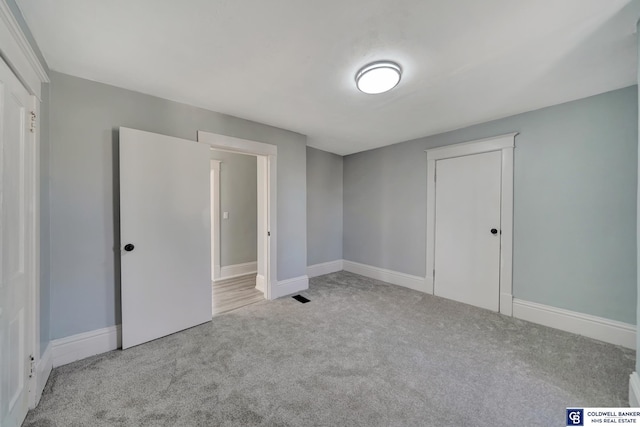 unfurnished bedroom featuring light carpet