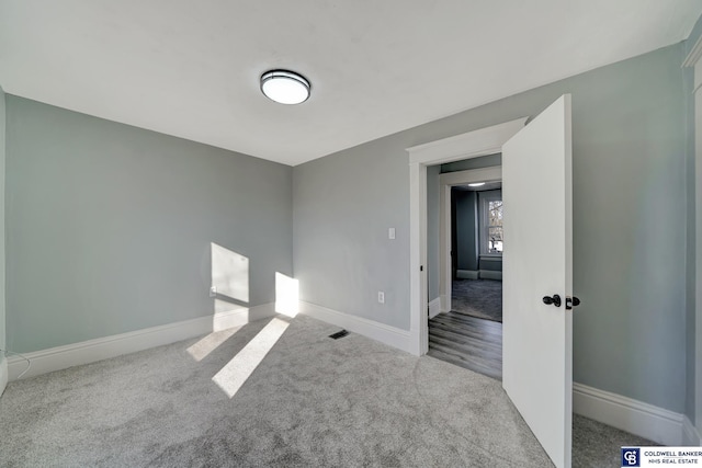 spare room with light colored carpet