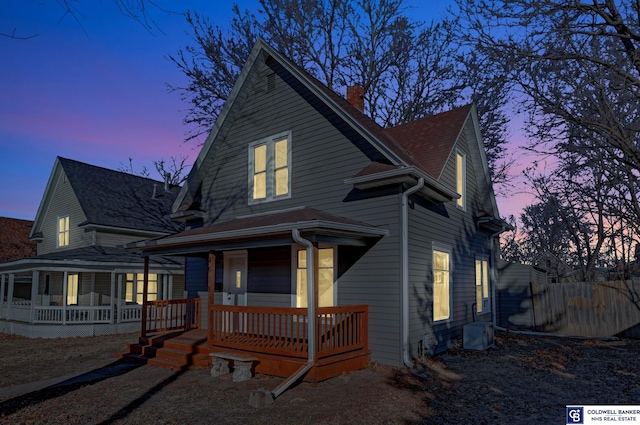 view of front of house featuring cooling unit and covered porch