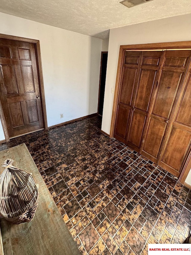 foyer featuring a textured ceiling