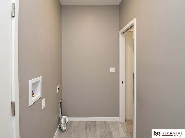 washroom featuring washer hookup, hookup for an electric dryer, and light hardwood / wood-style floors