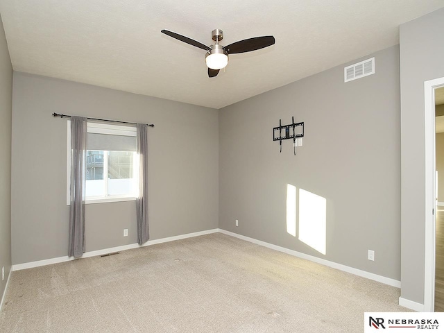 carpeted empty room with ceiling fan