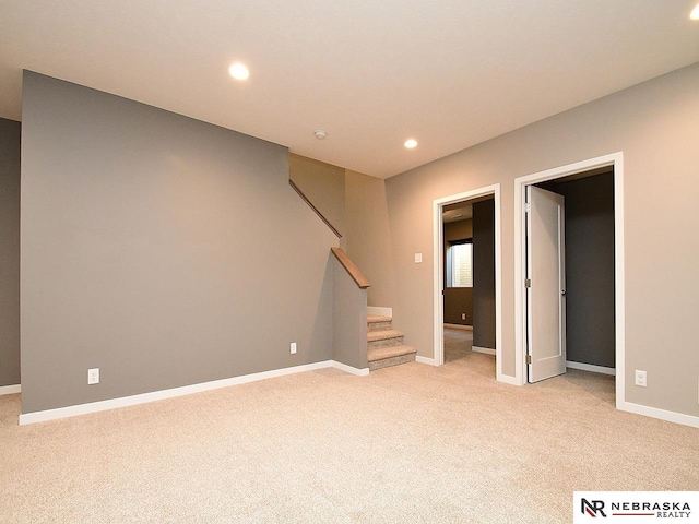 basement featuring light colored carpet