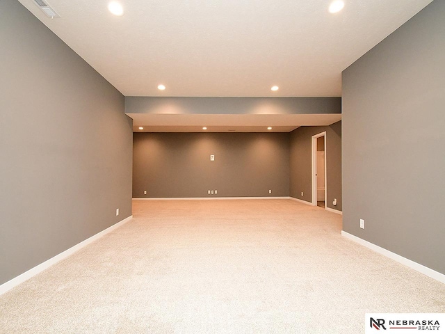 basement featuring light carpet