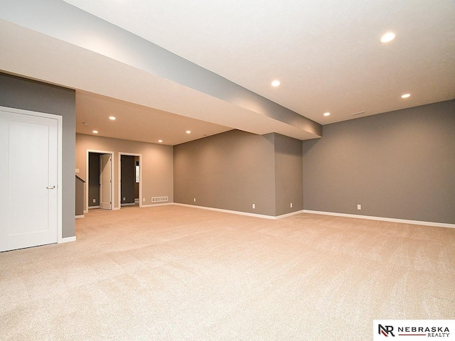 basement featuring light carpet