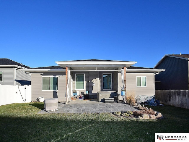 rear view of property featuring a yard and a patio area