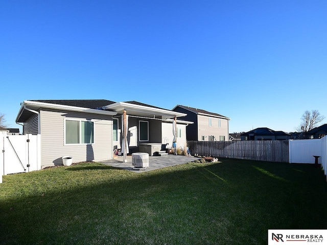 rear view of house with a yard and a patio area