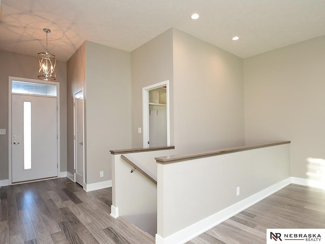 entrance foyer with an inviting chandelier and hardwood / wood-style floors