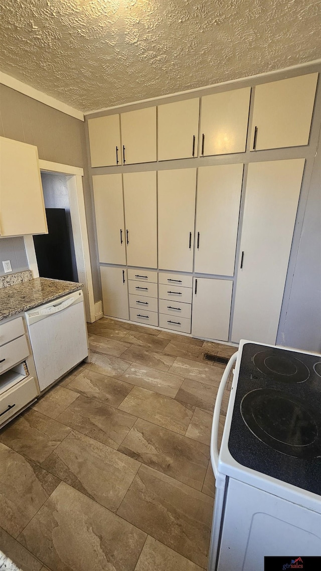 kitchen with white cabinetry, white appliances, light stone counters, and a textured ceiling