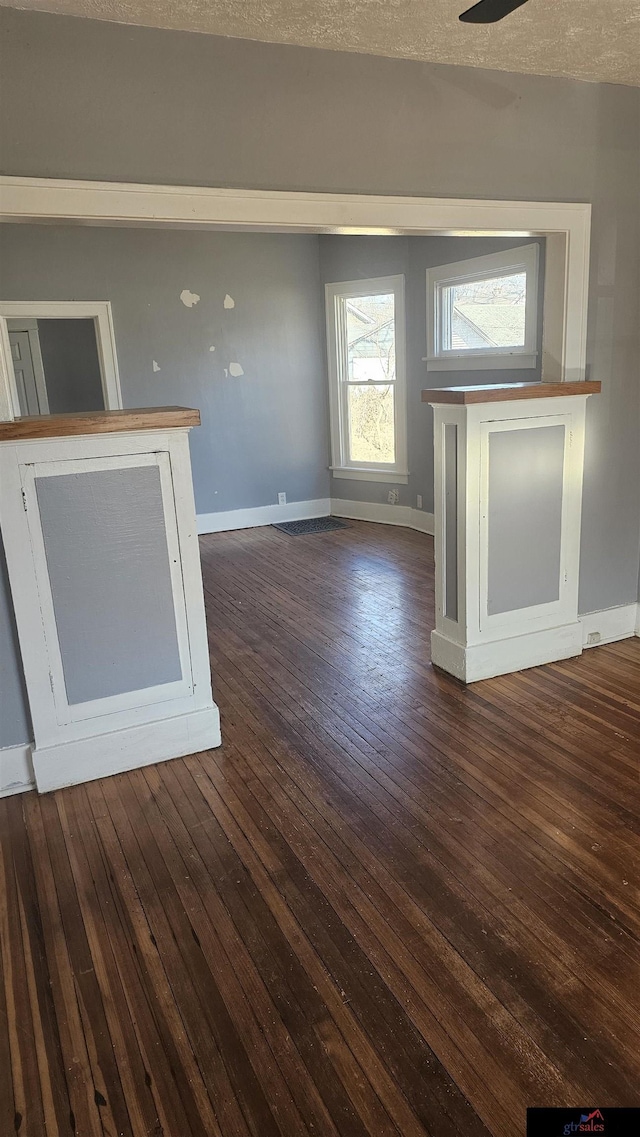 unfurnished living room featuring dark wood-type flooring