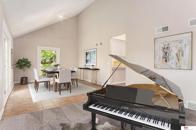 miscellaneous room featuring tile patterned flooring and high vaulted ceiling