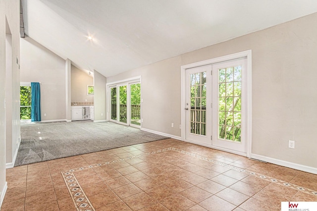 interior space featuring high vaulted ceiling and tile patterned flooring