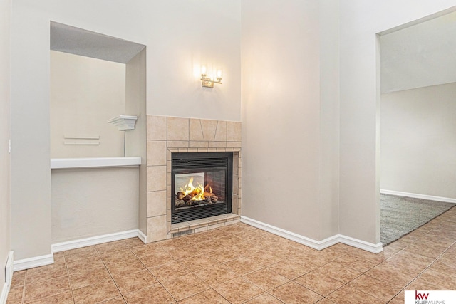 unfurnished living room with tile patterned floors and a tile fireplace