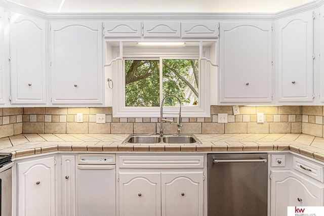 kitchen with sink, dishwasher, white cabinetry, backsplash, and tile counters