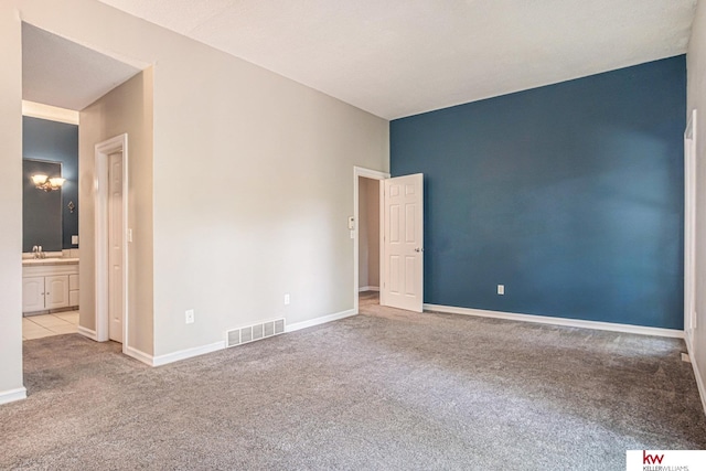 carpeted spare room with sink