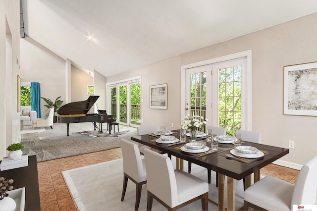 dining room with light tile patterned flooring and high vaulted ceiling