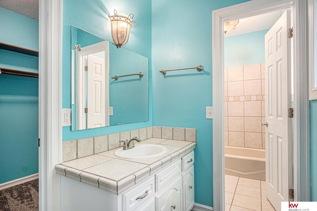 bathroom with vanity, a bathing tub, and tile patterned floors